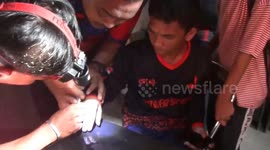 dramatic officers evacuate rings from citizens' finger in indonesia