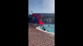 Little girl's pool slide ends with her unexpectedly landing on dad