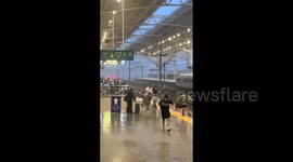 Chinese woman nearly falls off platform chasing wind-blown suitcase at railway station