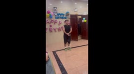 Children spell 'Happy Birthday' with fans for grandmother's party