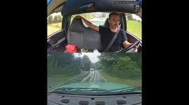 Truck driver narrowly avoids crash by calmly swerving around vehicle one handed