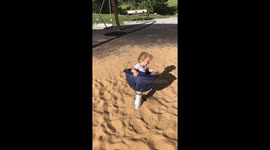 Funny video of toddler spinning on park seat and struggling to find his balance