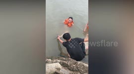 People laugh and film agony of fisherman caught on fishing hooks