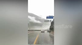 Cars narrowly escape massive rockfall with huge boulders on busy road