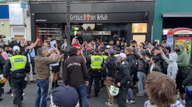 England flag bearer clashes with left-Wing crowd during standoff in north finchley