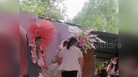 Bride and groom receive necklaces made of money from his eight sisters as wedding presents