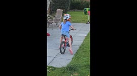 Young girl rides her bike straight into a big spiky bush and cries out