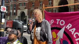 Actvist Ulrike Schmidt speaks at an anti-far-right demo outside Reform UK offices