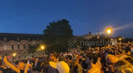 Crowds gather to watch the Olympic couldron rise into the air for the last time in Paris
