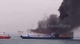 A large motor ship carrying passengers in Indonesia caught fire, causing thick black smoke