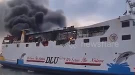 A large motor ship carrying passengers in Indonesia caught fire, causing thick black smoke
