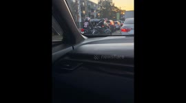 Motorbike rider opens car door in traffic after car passenger disables bike as a joke