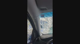 Car leaks during tidal wave car wash due to tilted sunroof in Minot, North Dakota