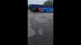 Raccoon takes food while others hide under trash bins in Cambridge, Ontario