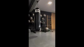 Gym enthusiast's unexpected fall while kicking bag in socks after training
