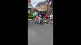 Neighborhood kids cheer little boy for his first bike ride without stabilizers