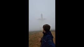 Plane spotter films as low-flying Boeing 787-10 aircraft emerges from fog