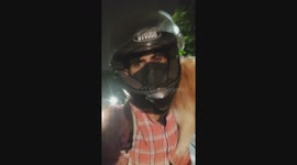Motorcycle ride with cat on shoulder captured in Bengaluru