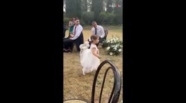Little girl runs to join parents as they walk towards the wedding aisle
