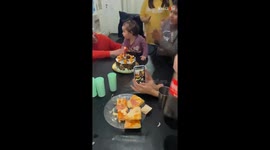 Little girl blows out candle on her first birthday with a finger