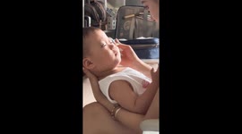 Mother attaches fake eyelashes to her baby son