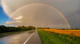Perfect rainbow forms over corn fields in New York