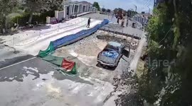 Cement mixer rolls backwards down bridge and topples over