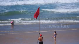 Red flag safety Beach closure by RNLI Lifeguards with thousands ordered out of the sea. fistral Beach, Newquay, Cornwall, UK