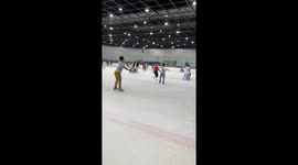 Ice skater topples over while showing off on public rink