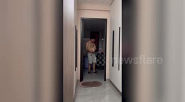 Dad soothes baby by attaching pacifier - to his chest