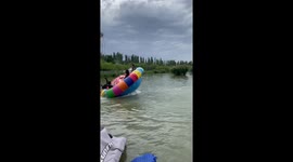 Inflatable UFO ride throws riders into river