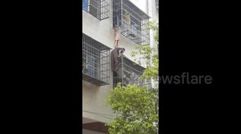 Heroic neighbours save girl dangling from second-floor window in China