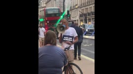 Unusual protest as man holds 'kids are horrible' sign outside toy shop in London