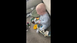 Adorable baby's joy knows no bounds while playing with Maine Coon kitten