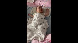 Party nap! Newborn baby dances in his sleep