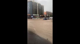 Rain storm turns road into muddy river in China