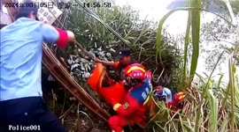 Police and firefighters rescue trapped motorists as van dangles on cliff edge near Chinese reservoir