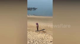 Sanitation workers caught burying trash on beach