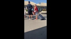 Person pulls suitcase upside down in Naples, Italy