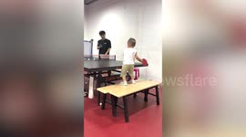 Toddler plays table tennis with grandmother like professional