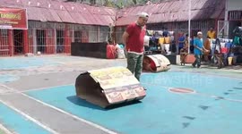 Indonesian inmates race in cardboard tubes to celebrate Independence Day