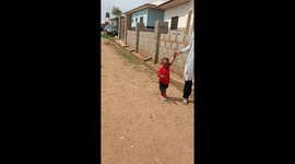 Baby Dominion and his mother walked side by side as she held his hands to encourage him to practice walking