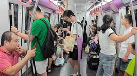 China: Passengers on a subway train in Beijing