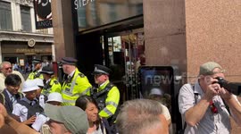 Police guard Angus Steakhouse in Londons Picadilly Circus at the Animal Rights Protest in London filmed on Saturday 17th August 2024