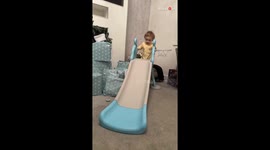 Toddler excitedly climbs indoor slide for the 1st time, only to experience a funny backward fall