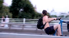 Bike event participants pull wheelies on the wrong side of the road on Waterloo Bridge