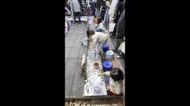 Children catch fish from tray in this market game
