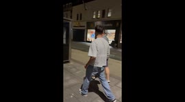 Bus stop mishap: Clumsy friend's head strikes in a stand