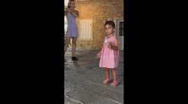Little girl enjoys ice cream bliss and flute melodies in Budva