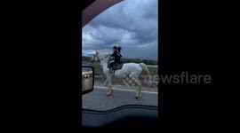 Young Girl Rides Horse as Lightning Strikes in China